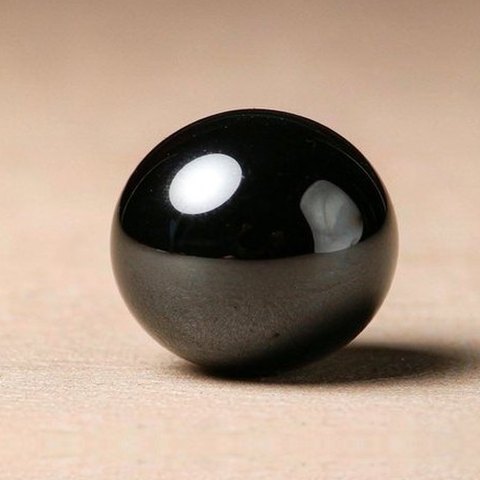 Black obsidian bead, macro photo