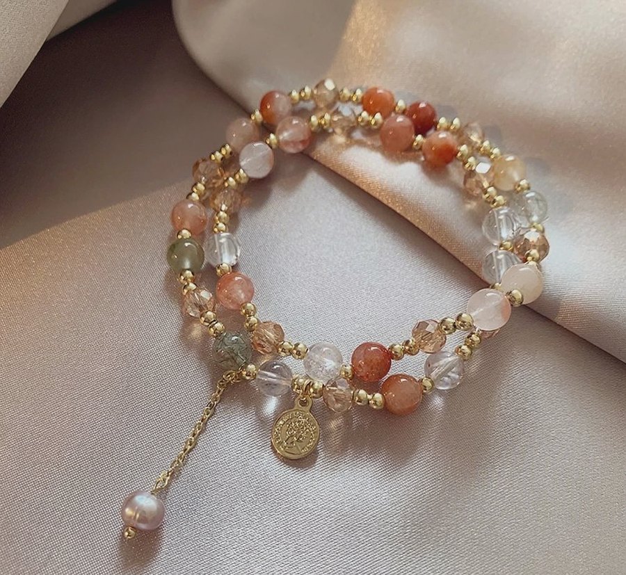 Hand-strung crystal bracelet — strawberry quartz, rutilated quartz and gold spacers on silk